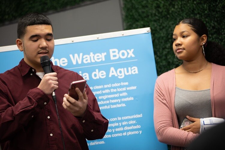 Latinx Leadership Academy youth Tomás Tello, 16, beside Suamy Gutiérrez, 17, recites a poem to residents during the public showing at the Latinx Technology and Community Center on Monday, Dec. 2. 