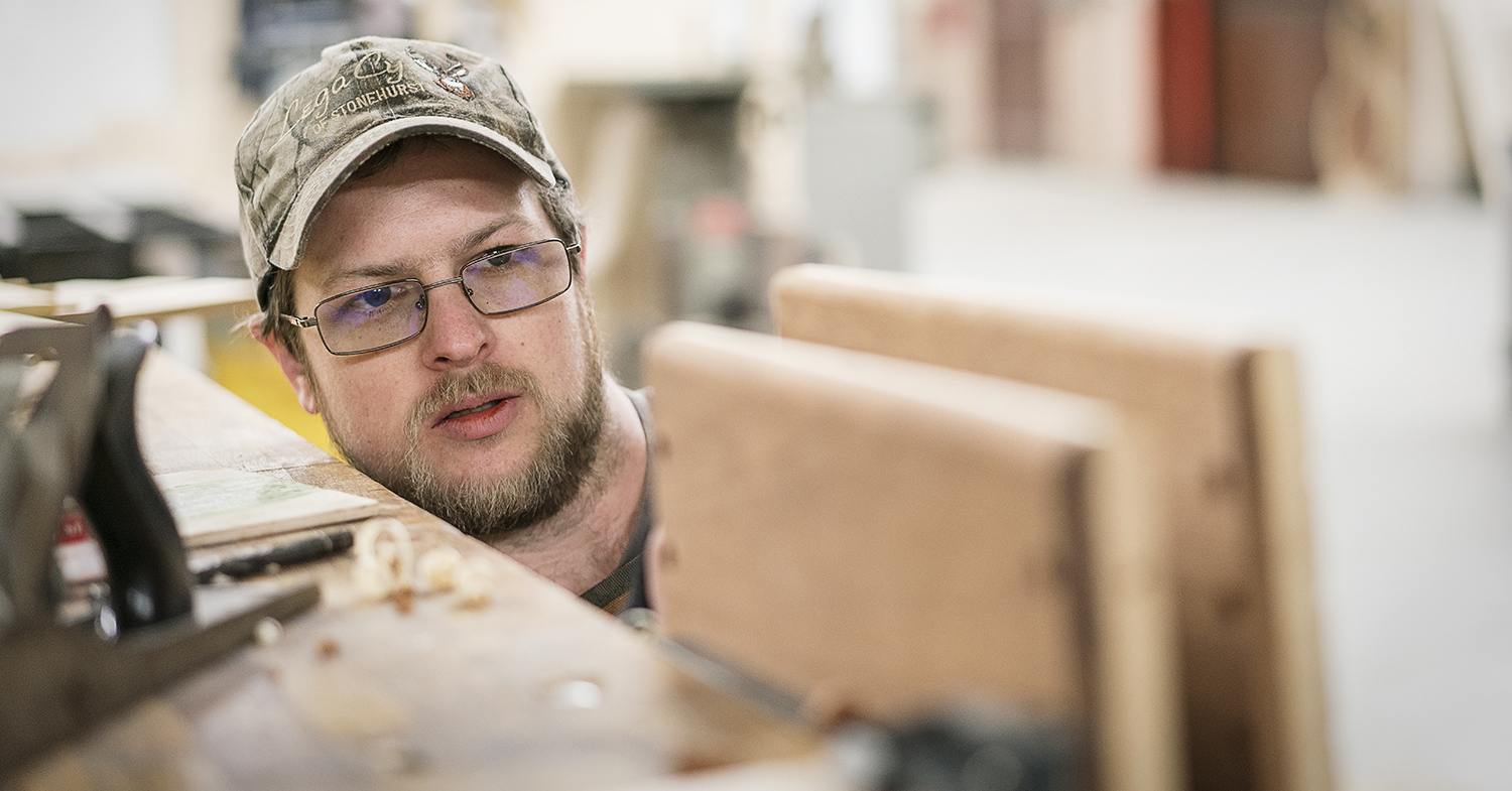 Flint, MI - Friday, February 2, 2018: As he rounds the edges of his project, Flint resident Mike Callahan checks to make sure his progress is even and smooth at Factory Two in Flint.