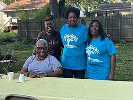 Flint native Jeanette Edwards stands in the middle and smiles with fellow Brownell-Holmes community members on Sept. 12, 2024.