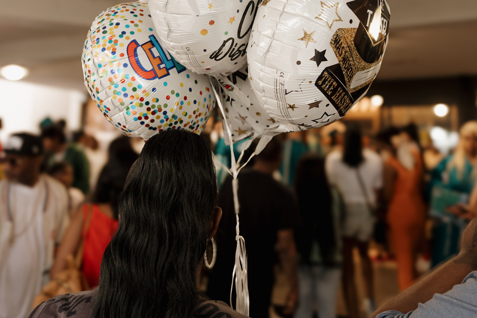 As the ceremony concludes, parents await their graduates with balloons and other gifts on June 4, 2024. 