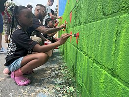 Students from Flint Cultural Center Academy add hearts to the Rx Kids mural on the Buick Gallery wall during a workshop with Flint Public Art Project.