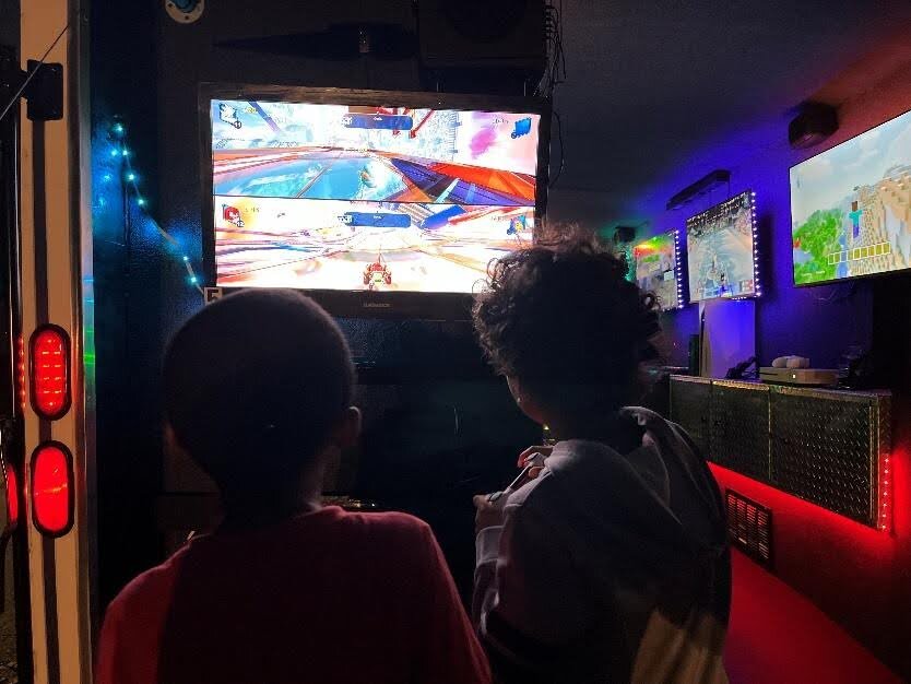 Children play on one of the five screens in the Park and Play Mobile Gaming truck.