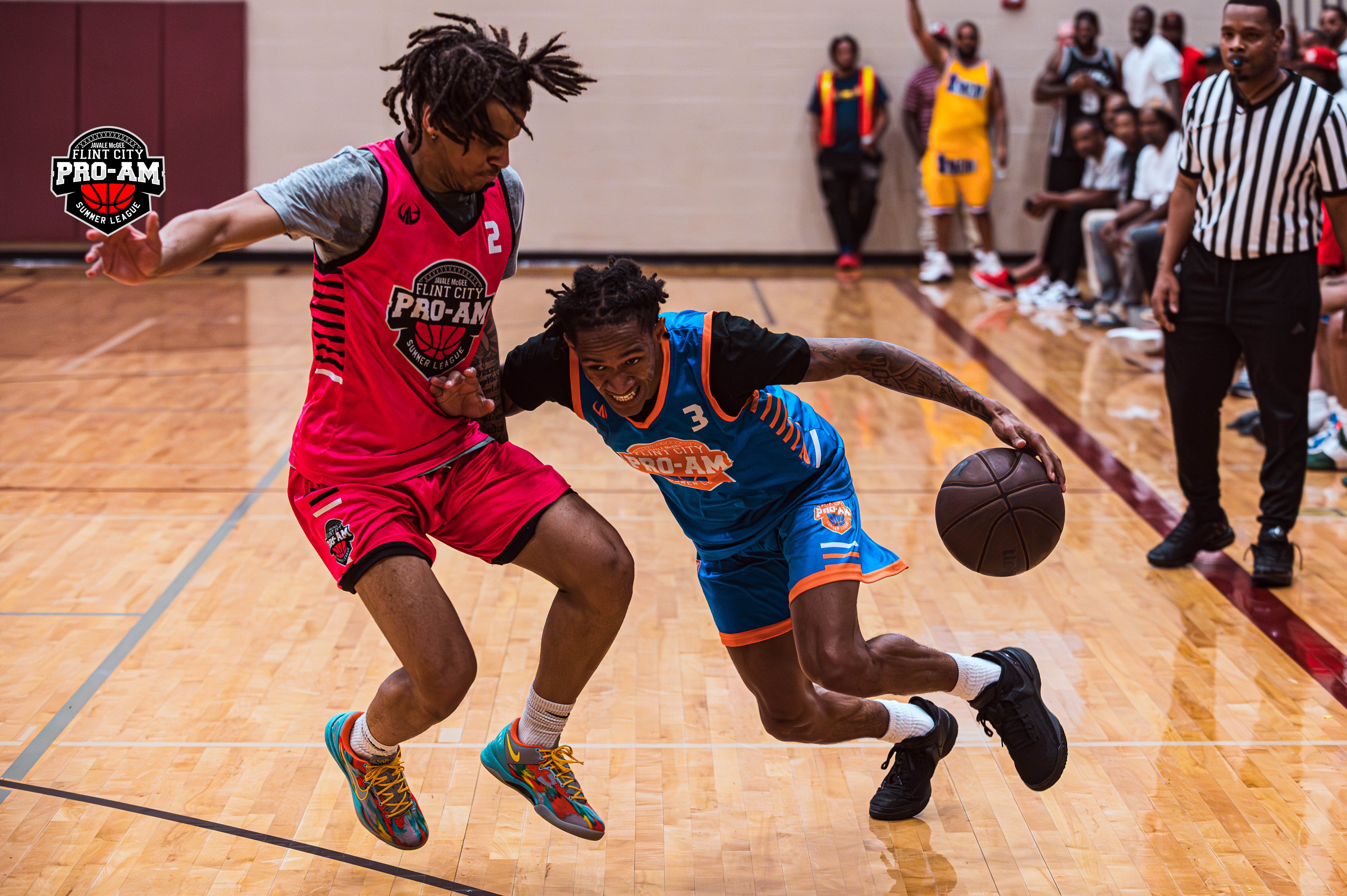 Eastern Michigan standout Jalen Terry dribbles past Stetson University guard Mehki Ellison at the JaVale McGee 2024 Flint City Pro-Am.  