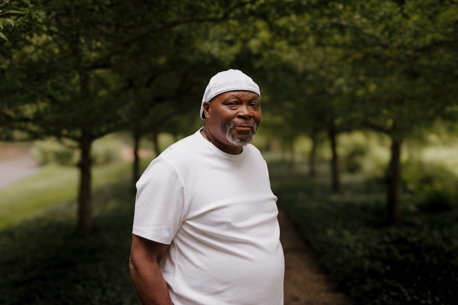 Pictured on a walking path at Applewood Estates on August 11, 2024, former City of Flint police officer Ronnie Summers stands proud of his achievements.