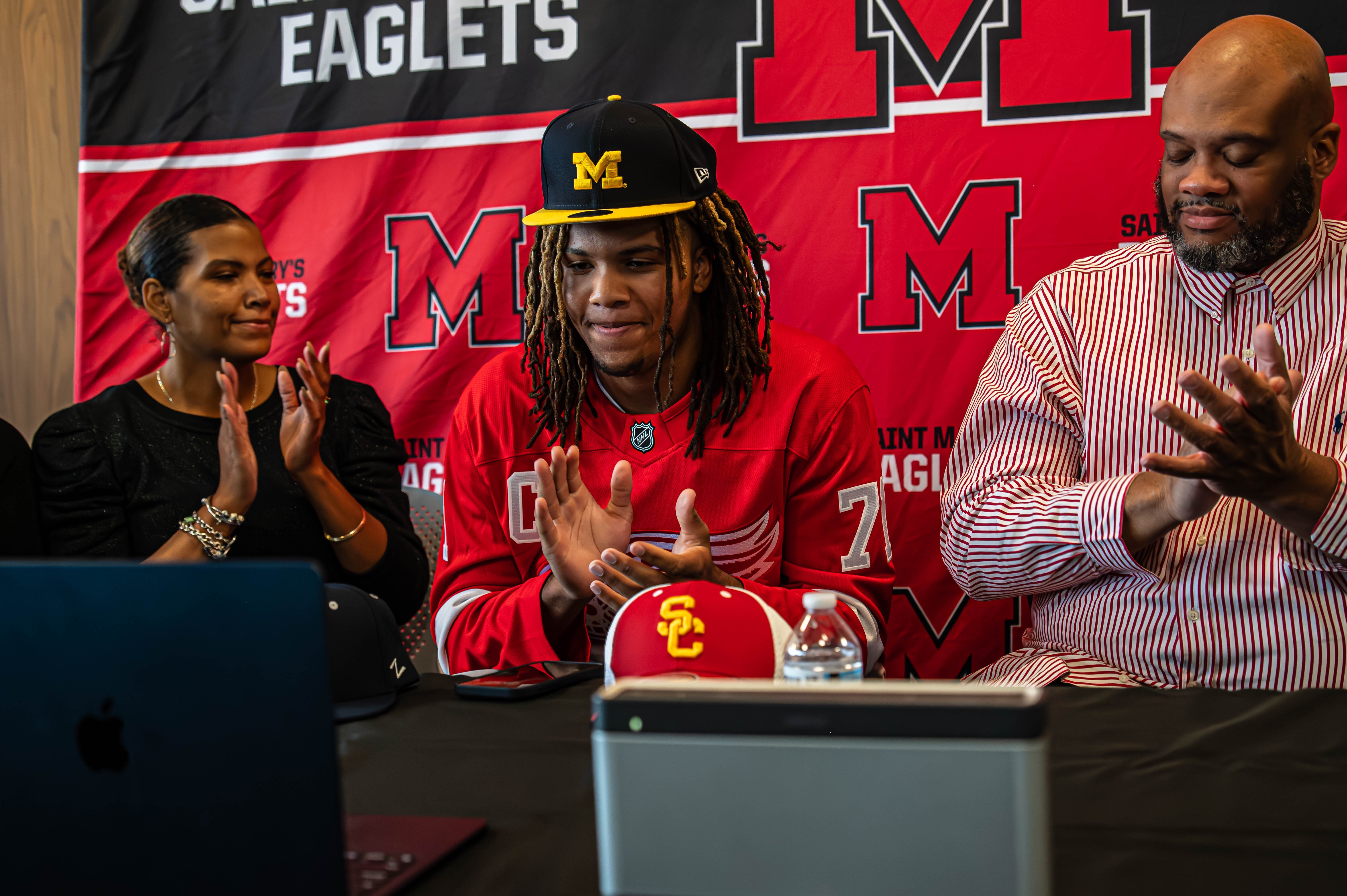 Trey McKenney with his mother and father during his announcement to commit to the Wolverines.