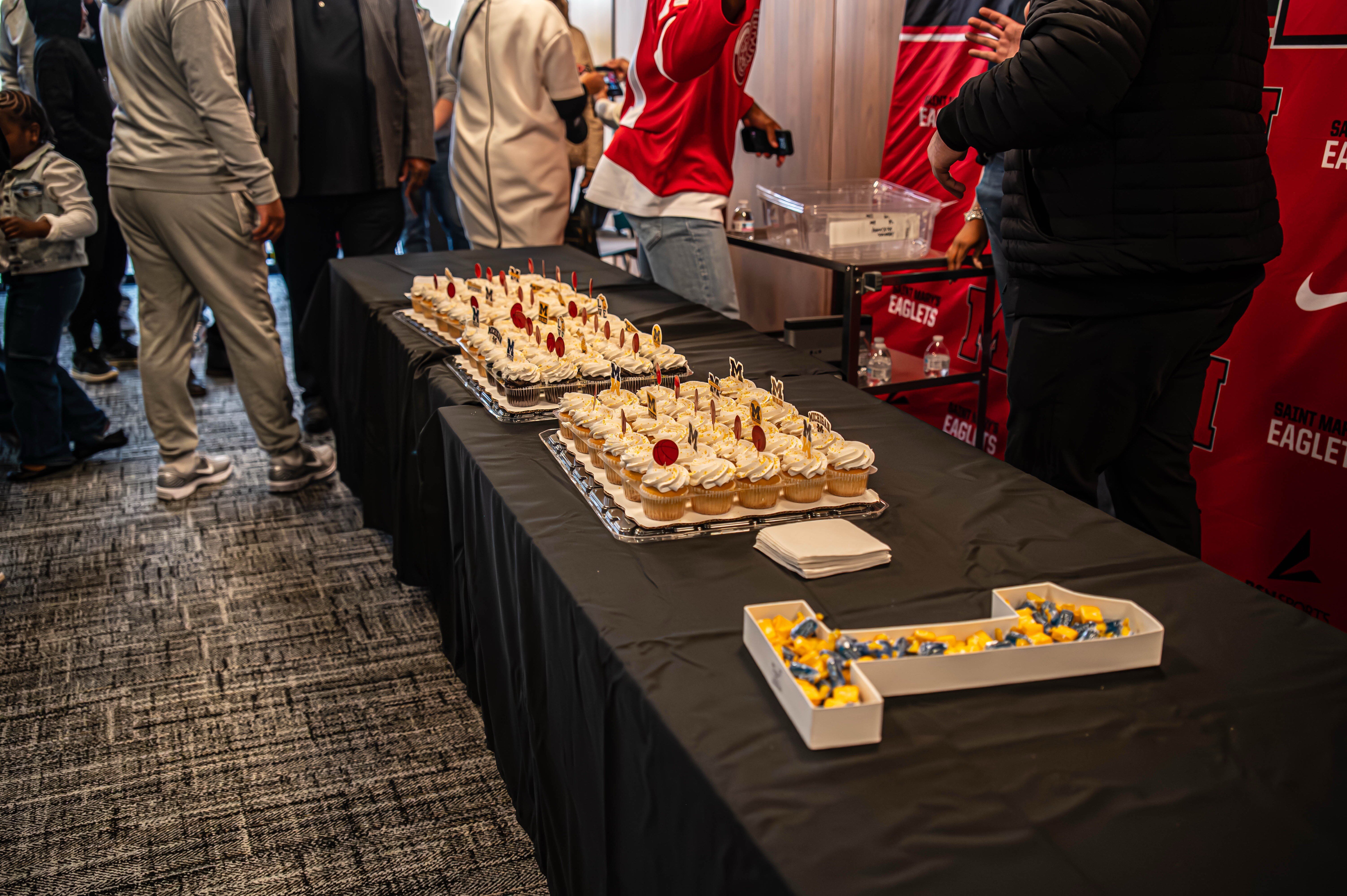 Treats and cupcakes adorned in the University of Michigan colors.