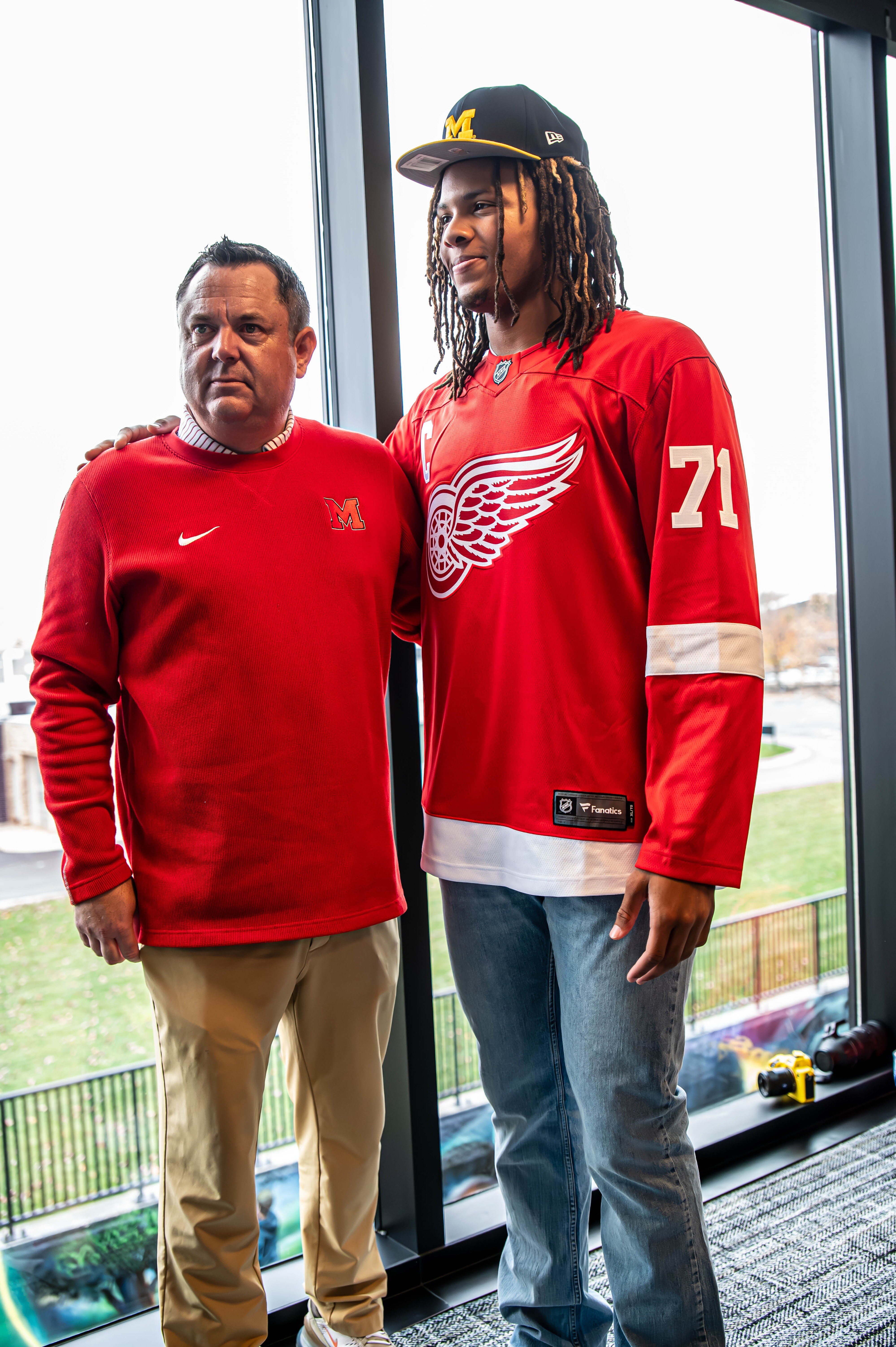 Orchard Lake St. Mary’s basketball coach Todd Covert congratulates Trey McKenney on his commitment decision.